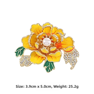 Detail of yellow peony flower brooch with white pearl and rhinestone leaf accents