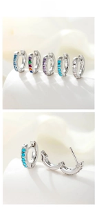 Macro detail of s925 silver hoop earrings featuring colorful cubic zirconia settings