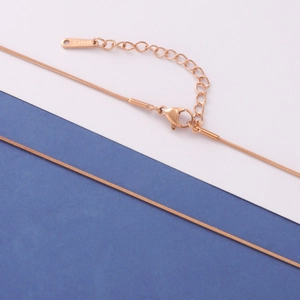 Detail of rose gold stainless steel snake chain with lobster clasp and S.STEEL tag