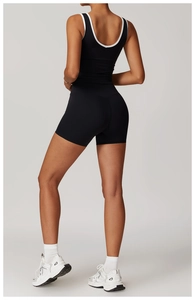 Detail of high-waist yoga shorts with ergonomic V-seam for bum lifting effect in black