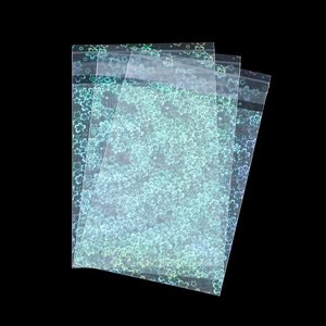 Close-up of holographic laser storage bags with floral patterns on black background