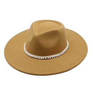 Detailed view of camel wool fedora hat featuring elegant white pearl beaded band trim