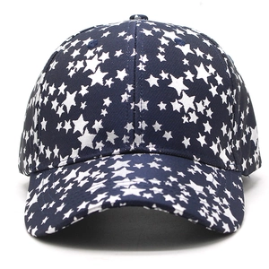 Detailed close-up of dark blue baseball cap with white star prints and curved brim