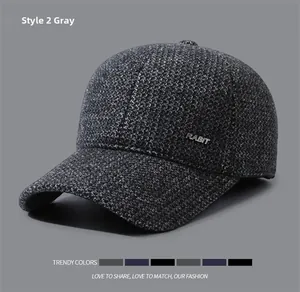 Detail showing the gray tweed texture and metal RABIT logo on a men's winter cap