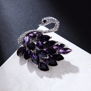 Makroansicht der Schwanenbrosche mit lila Kristallen im Marquise-Schliff und Strass