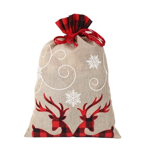 Detail of linen Christmas gift bag with red plaid reindeer motif and drawstring