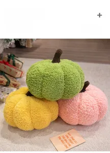 Detail of soft pumpkin plush pillows in green, yellow and orange colors with fuzzy texture