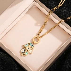 Golden Hamsa Hand necklace with evil eye pendant on a mixed clip and link chain