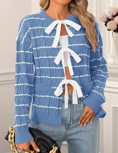 Detail of blue and white striped knit cardigan featuring three white decorative bows