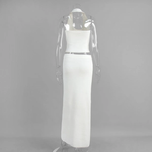 Detail of white ribbed knit set showing halter top backless design and high-waisted skirt