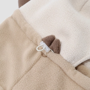Macro detail of kids winter fleece hat showing drawstring buckle and cute bear ear design