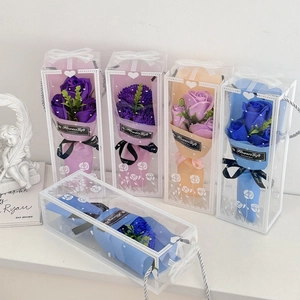 Detail of multi-colored soap carnation bouquets in clear gift boxes with ribbons