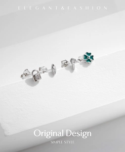 Detailed set of silver stud earrings featuring a green clover and tiny lock shapes
