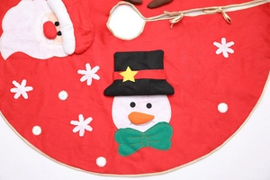 Detail of red plush Christmas tree skirt with Santa Claus snowman and gold piping edges