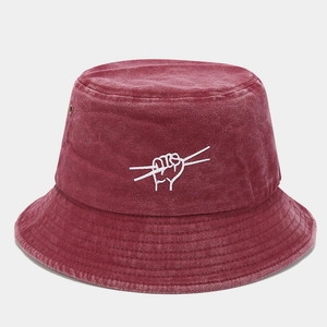 Close-up of wine red washed cotton bucket hat with white embroidery and metal eyelets