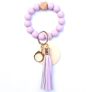 Light purple silicone bead bracelet keychain with wooden beads and leather tassel detail
