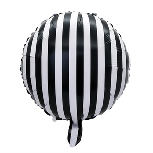 Close-up of a round black and white vertical striped foil balloon for racing party decor