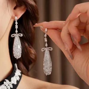 Elegant silver drop earrings with bow design and shimmering cubic zirconia for women