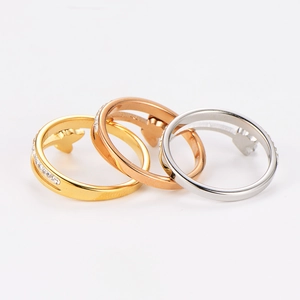 Detailed view of butterfly rings set in gold, rose gold and silver with zircon inlay