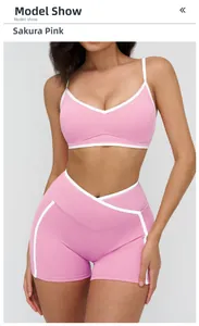 Detail of cherry pink sports bra and high-waist shorts with contrast white piping