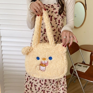 Close-up of fluffy lamb wool tote bag featuring a cute cartoon bear drinking milk tea