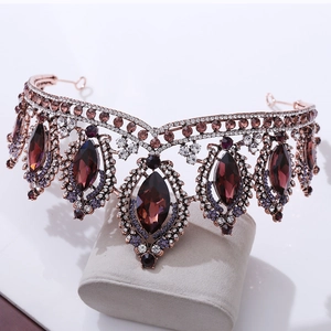 Macro detail of rose gold bridal crown with purple crystals and white rhinestones