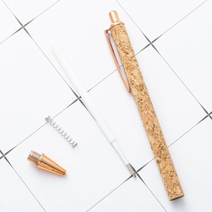 Cork texture ballpoint pen with rose gold metal parts and internal components shown