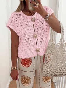 Pink knit hollow short sleeve cardigan featuring decorative golden sun buttons on model