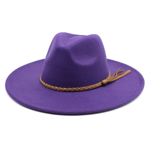 Macro view of purple wool fedora with brown woven belt and decorative side fringe