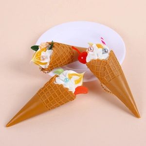 Three realistic ice cream cone keychains with white cream toppings and gold bead chains