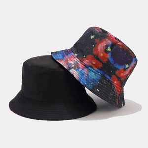 Close-up of dual-style bucket hats with galaxy digital print and solid black cotton fabric