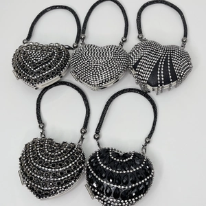 Five styles of heart-shaped evening bags featuring sparkling rhinestones and metal handles