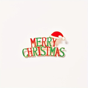Golden Christmas brooch with Merry Christmas lettering and Santa hat enamel detail