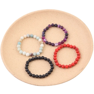 Detail of 8mm natural stone beaded bracelets including tiger eye and agate in a tray