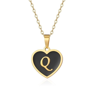 Close-up of heart-shaped pendant with black enamel and golden letter Q on link chain