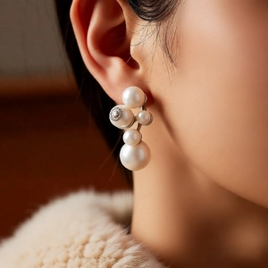 Macro detail of elegant pearl cluster earrings with fine metal carving details