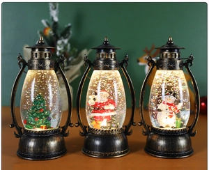 Close-up of lighted bronze Christmas lanterns with snow globes and festive figurines