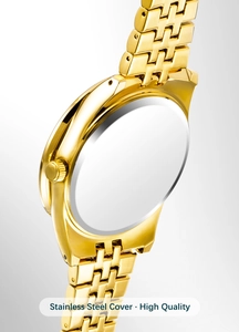 Macro view of the stainless steel back cover and polished gold-toned metal watch band