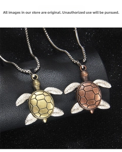 Detailed view of vintage sea turtle pendants in bronze and red copper with snake chains