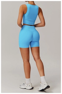 Detail of high-waist scrunch butt yoga shorts and crop top in vibrant blue sports set