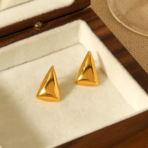 Minimalist 18K gold triangle stainless steel stud earrings on beige velvet jewelry box