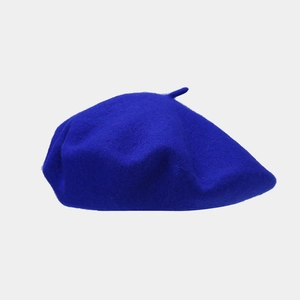 Close-up of a blue wool beret showing high-quality fabric texture and soft felt finish
