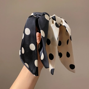 Elegant polka dot bow hair clips in black and beige silk finish for women's hairstyling