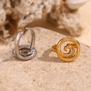Detail of 18K gold and silver plated spiral open rings on a natural stone base