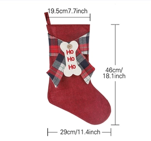 Detail of red Christmas stocking with plaid cuff and bone tag showing 46cm height