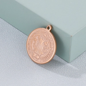 Rose gold St. Benedict medal pendant in titanium steel with detailed religious embossing