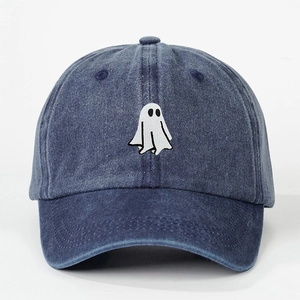 Close-up of ghost embroidery and washed denim texture on a vintage baseball cap