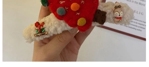 Detail of Christmas plush hair claw with white shearling, reindeer and holiday gift box