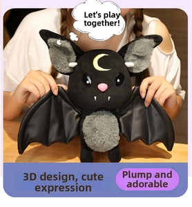 Detailed plush bat doll with yellow moon embroidery and leather-like wings held in hands