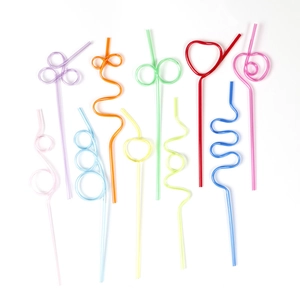 Creative colorful PET plastic straws in heart and spiral shapes on white background